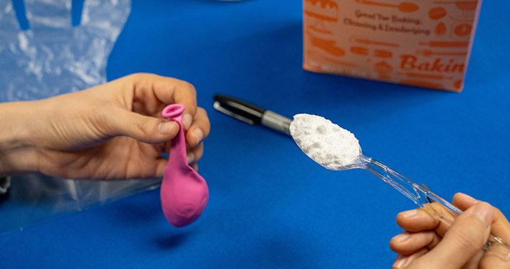 Pour a spoonful of baking soda into the uninflated balloon