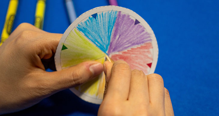 Stick a toothpick through the hole in the middle of the disk